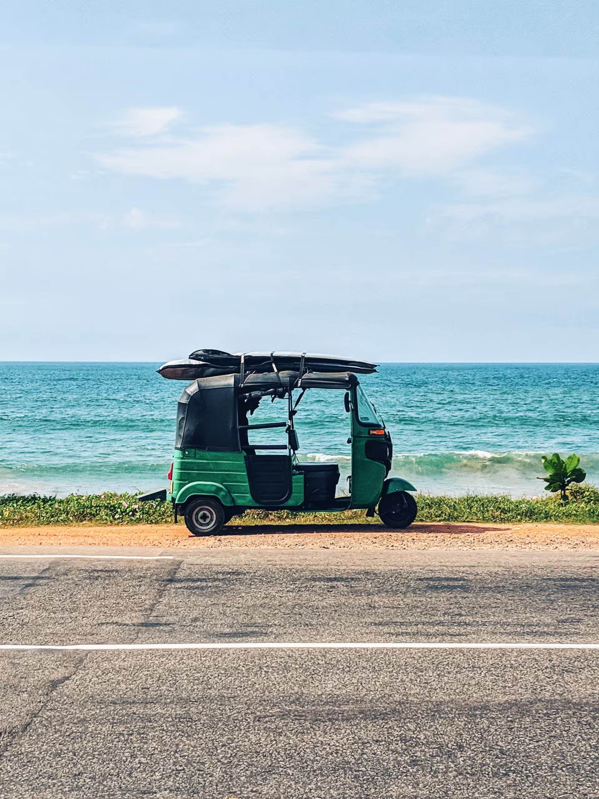 Tuk-Tuk City Safaris: Navigate the colorful chaos of Colombo or Jaffna in your own private chauffeured tuk-tuk. Best Sri Lanka Surf Guide - Surfer at Sunset.